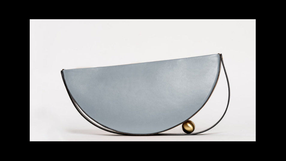 leather bag clutch with brass design detail
